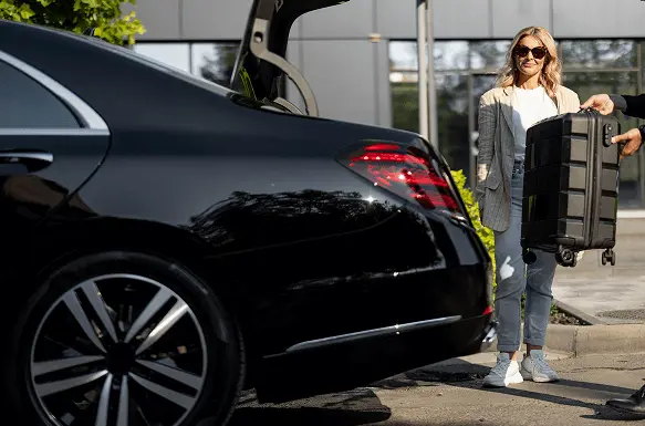 Luxury black car with professional driver providing premium transfer service